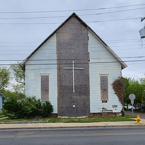 Front view of the church showing fire damage and missing windows